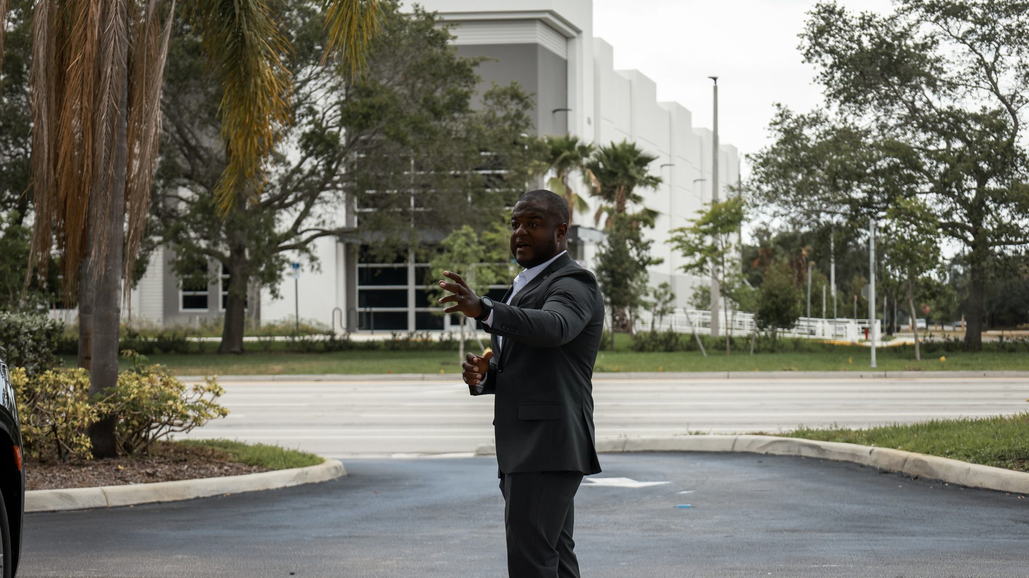An ARDENT Executive Protection Agent walking a route in advance of a client arrival. No client is present or identifiable.